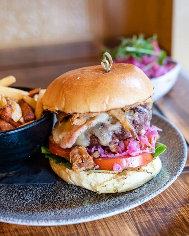 Peaky Blinders Manchester - Peaky Signature Burger ⁠ Ground brisket &  chunk steak patty, golden caramelised onions, black wax cheddar, shredded  lettuce and Peaky burger sauce. Perfectly paired with a cold pint