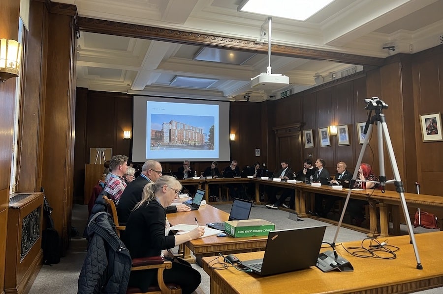 Councillors on Trafford\'s planning committee discuss the Victoria Warehouse scheme with an image depicting the iconic building on the big screen